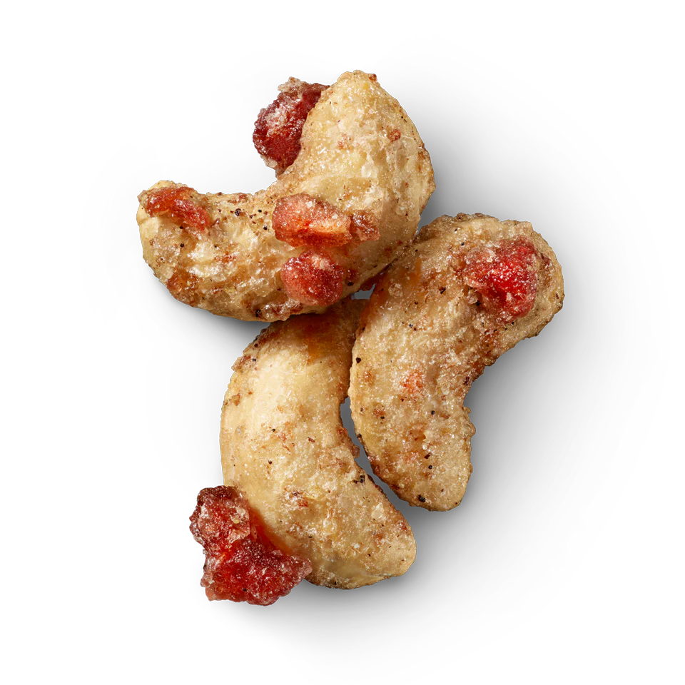 Glazed cashews with red pomegranate pieces and vanilla-speckled coating.